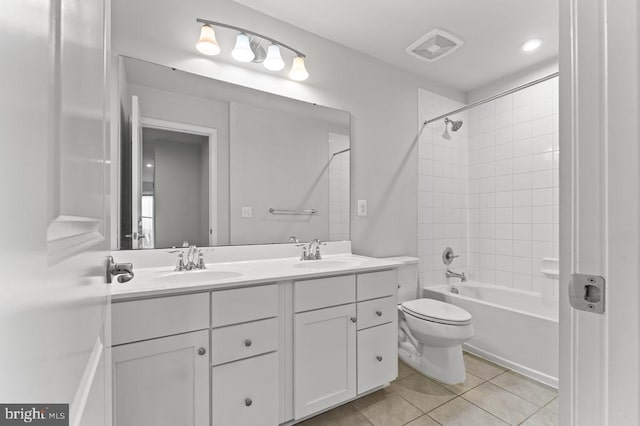 full bathroom with vanity, tile patterned floors, toilet, and tiled shower / bath