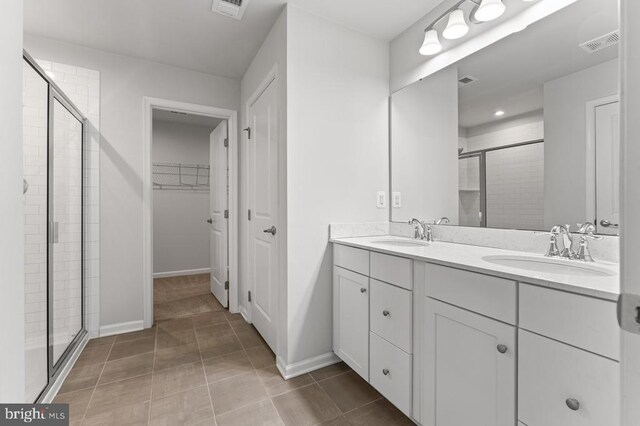 bathroom with vanity, tile patterned floors, and a shower with shower door