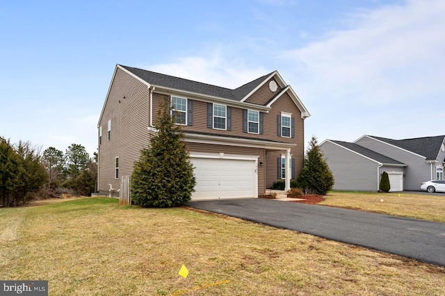 view of front property with a garage and a front yard