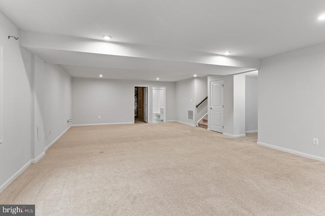 basement featuring light carpet