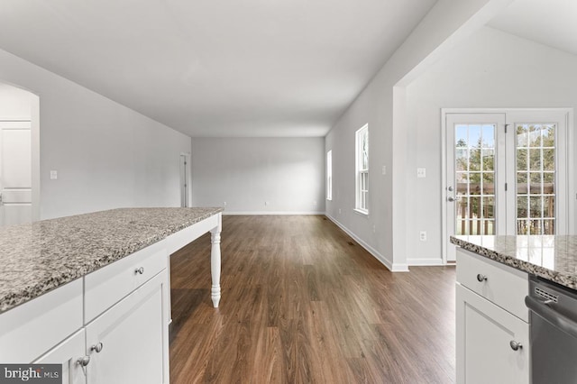 kitchen featuring dark hardwood / wood-style floors, built in desk, dishwasher, white cabinets, and light stone counters