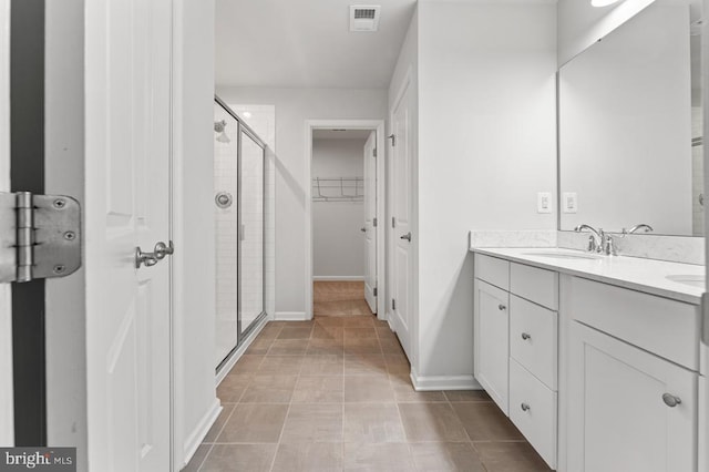 bathroom featuring an enclosed shower, vanity, and tile patterned floors