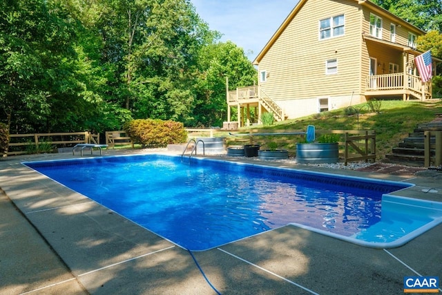 outdoor pool featuring stairs and a diving board