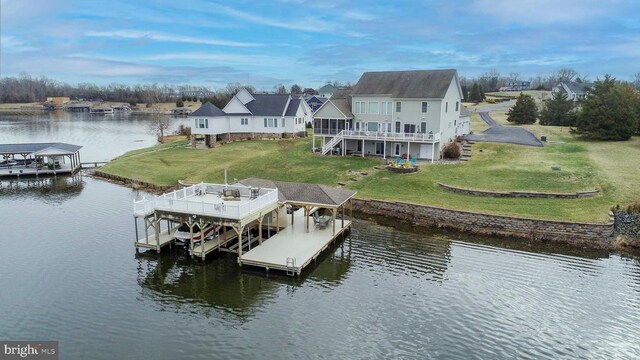 dock area with a yard and a water view