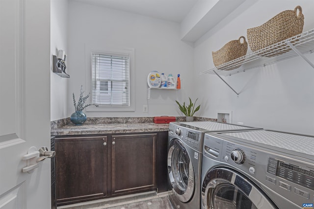 washroom with cabinet space and separate washer and dryer