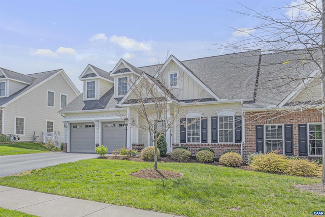 view of front of house with board and batten siding, aphalt driveway, a front lawn, and brick siding