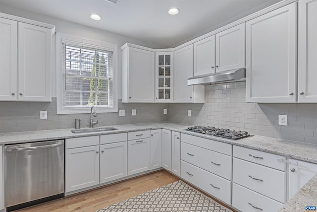kitchen featuring a sink, appliances with stainless steel finishes, and white cabinets