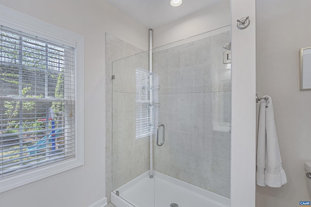 bathroom featuring baseboards and a stall shower