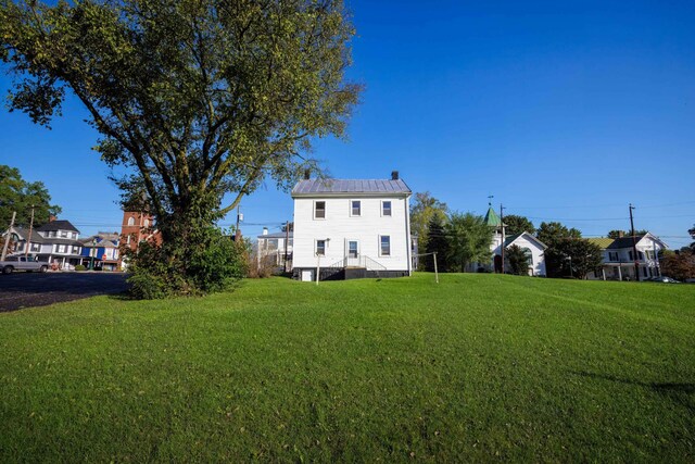 rear view of house with a lawn