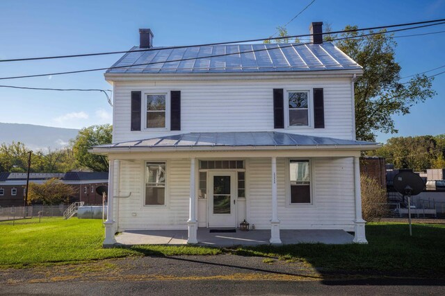 view of front of house with a front yard and a porch