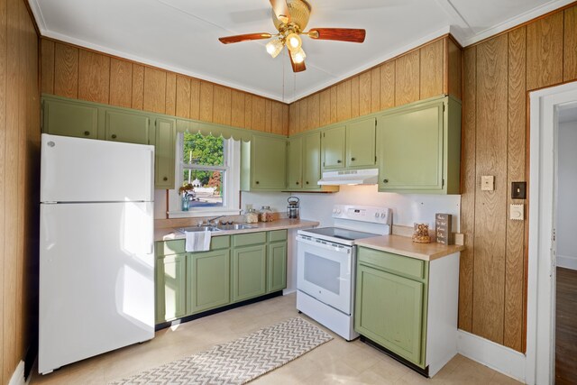 kitchen featuring sink, white appliances, ceiling fan, wooden walls, and green cabinetry