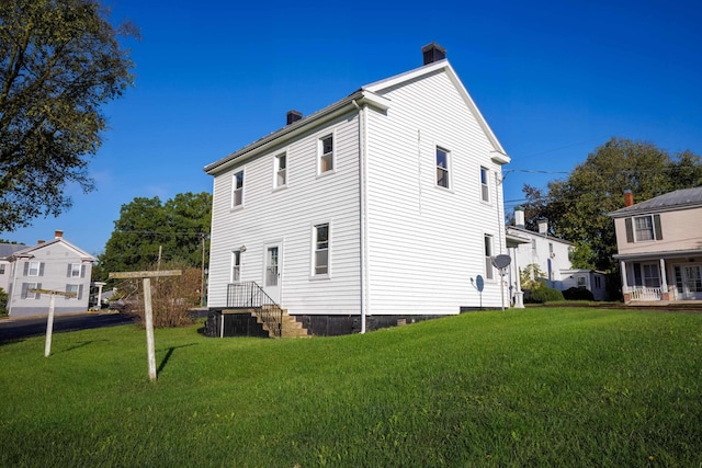 back of property with a lawn