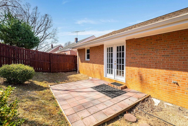 view of patio / terrace featuring french doors and fence