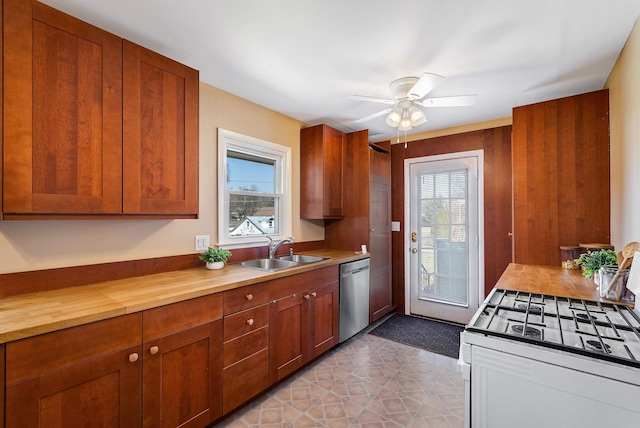 kitchen with stainless steel dishwasher, white range with gas cooktop, a wealth of natural light, and a sink