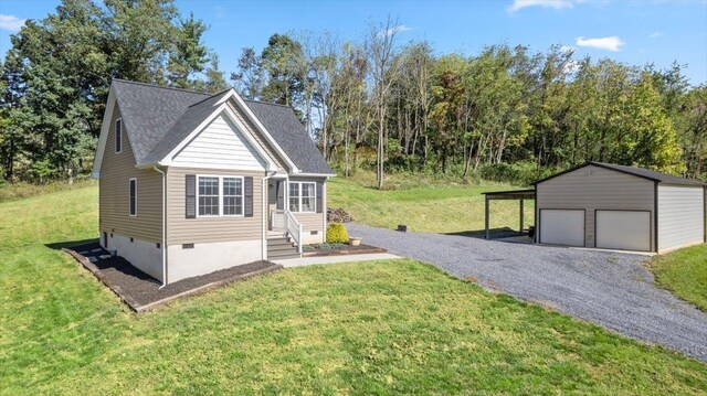 view of front facade featuring a carport, a garage, an outdoor structure, and a front yard