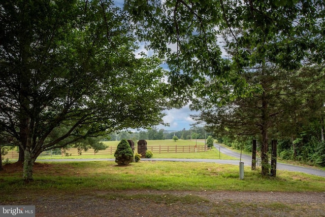 view of home's community with a lawn and a rural view