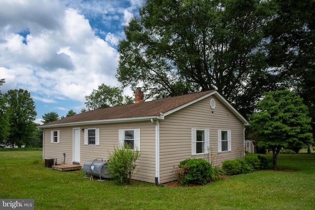 view of home's exterior with a yard and cooling unit