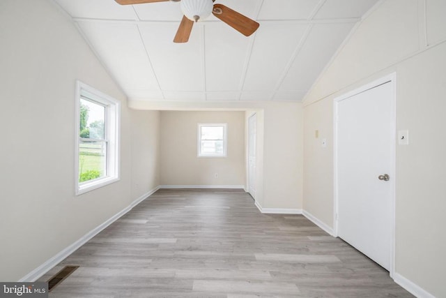 spare room featuring lofted ceiling, ceiling fan, and light hardwood / wood-style flooring