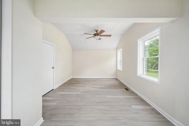 spare room featuring ceiling fan, vaulted ceiling, and light hardwood / wood-style flooring