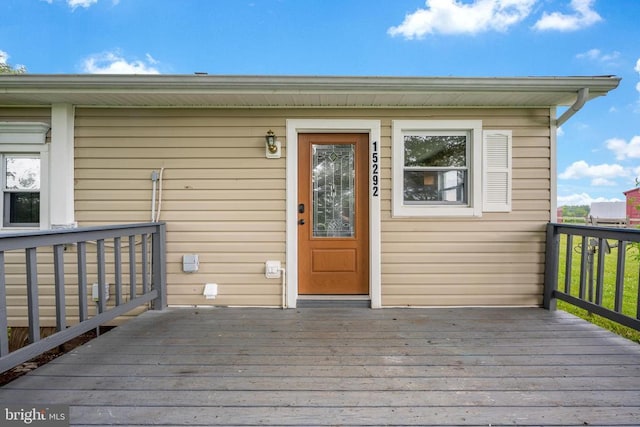 property entrance featuring a wooden deck