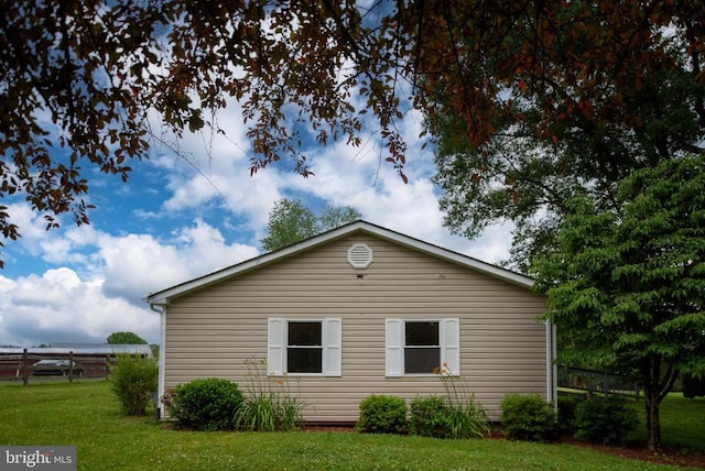 view of side of home with a lawn