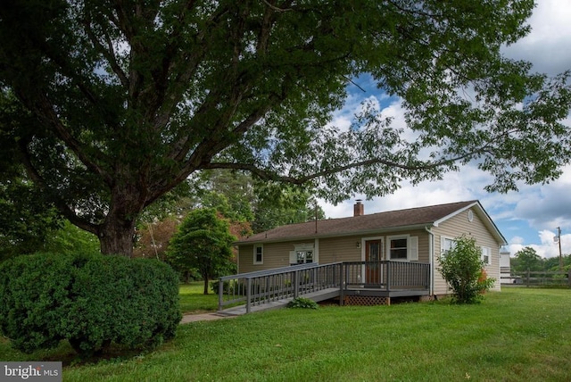 view of front of property with a wooden deck and a front yard