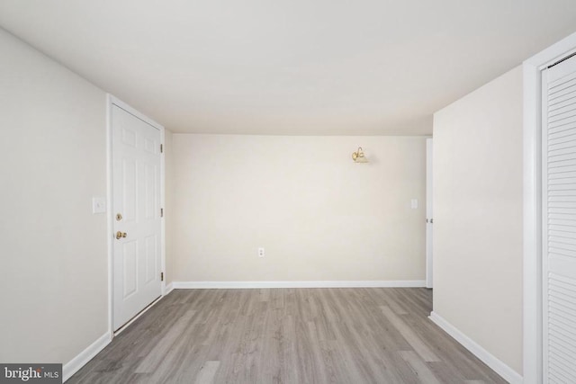 spare room featuring light wood-type flooring