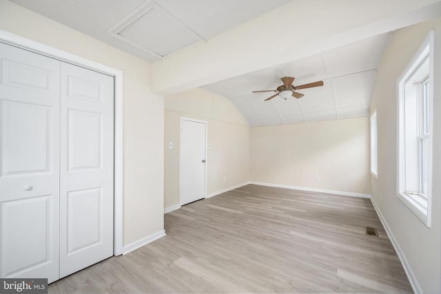 interior space featuring ceiling fan, vaulted ceiling, and light hardwood / wood-style flooring