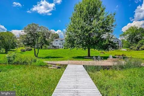 surrounding community with a patio and a yard