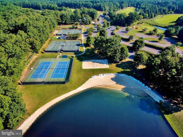 drone / aerial view featuring a water view and a wooded view