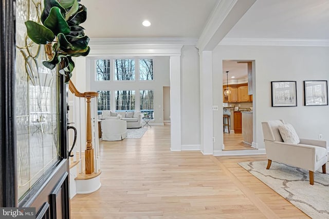 interior space featuring ornamental molding, light wood-type flooring, recessed lighting, and baseboards