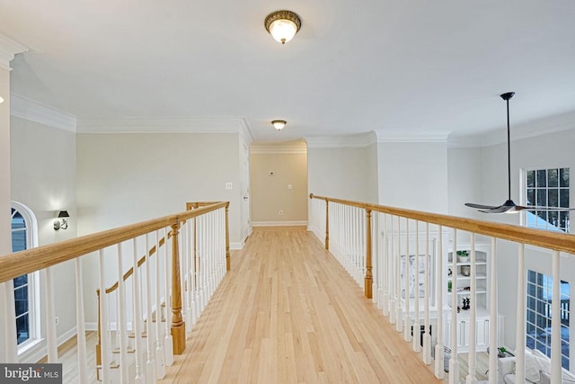 hallway featuring ornamental molding, wood finished floors, and baseboards