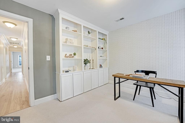 office area with visible vents, light carpet, baseboards, and wallpapered walls