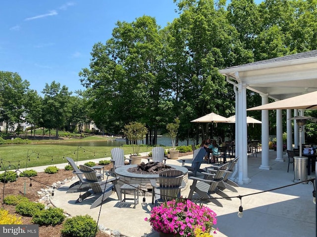 view of patio / terrace with a water view and an outdoor fire pit