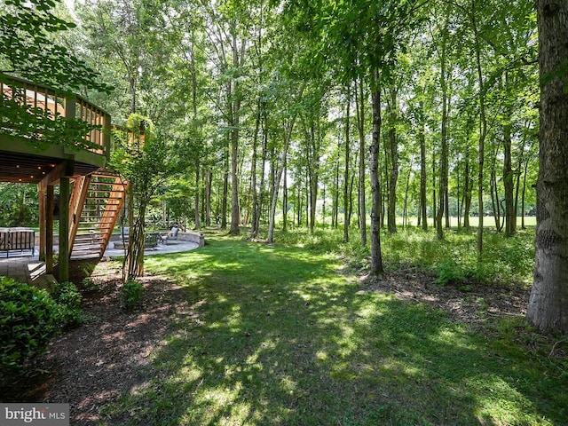 view of yard with stairway and a deck