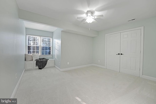 bedroom featuring light carpet, visible vents, and baseboards