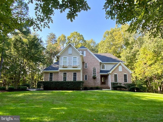 traditional-style home with a front lawn and brick siding