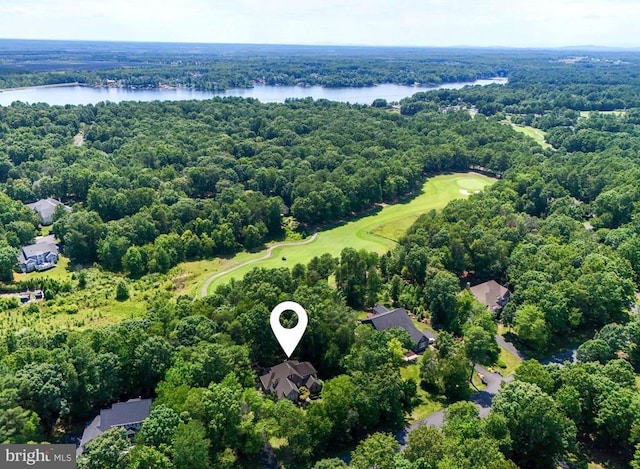 bird's eye view with golf course view, a water view, and a wooded view