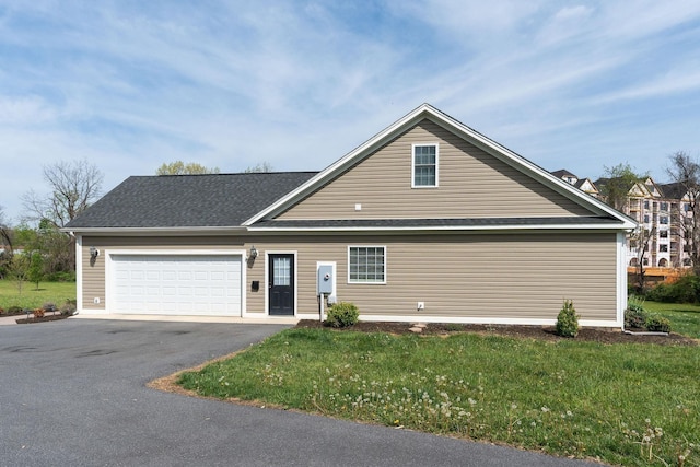 traditional-style house with driveway, a front yard, and a garage