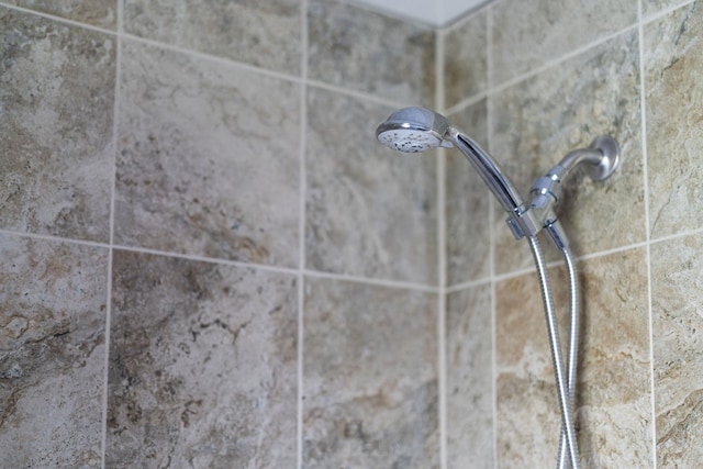 interior details with a tile shower
