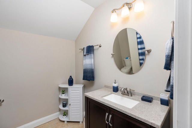 bathroom featuring tile patterned floors, vaulted ceiling, baseboards, and vanity