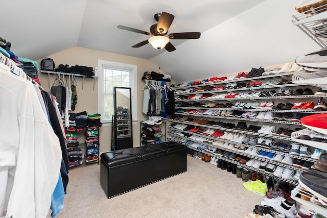 spacious closet featuring ceiling fan, carpet flooring, and lofted ceiling