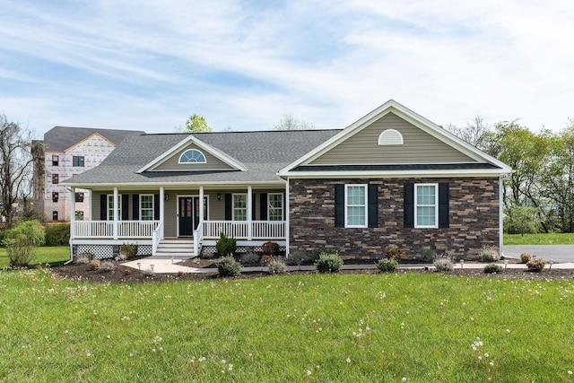 view of front of house featuring covered porch and a front lawn