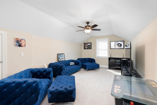 living area with ceiling fan, vaulted ceiling, baseboards, and carpet