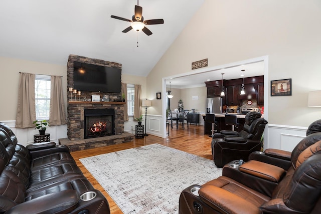 living room featuring wainscoting, a ceiling fan, and wood finished floors