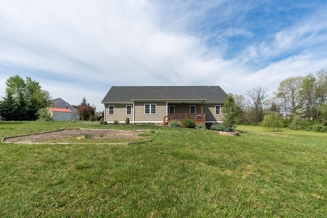 view of front facade with a front yard and a deck