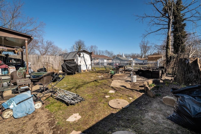 view of yard featuring an outbuilding, a shed, and a fenced backyard