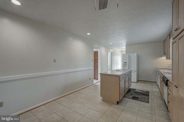 kitchen with a kitchen island, baseboards, dishwasher, light tile patterned floors, and white refrigerator with ice dispenser