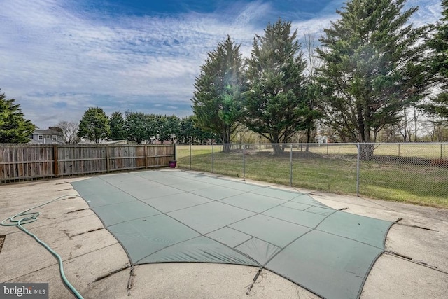 view of swimming pool featuring fence