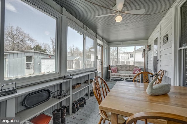 sunroom featuring ceiling fan